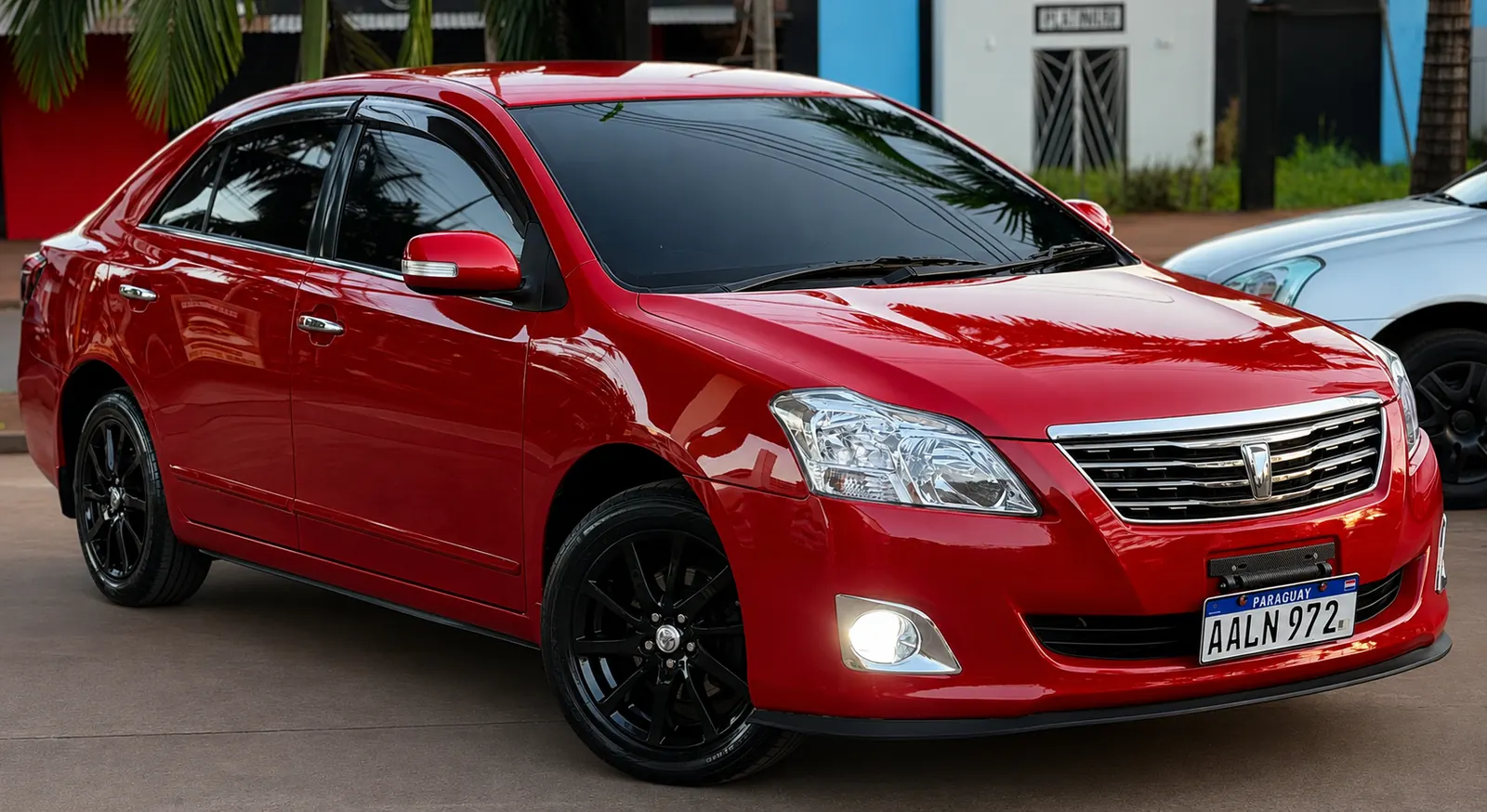 Toyota Premio roja, frente desde el lateral